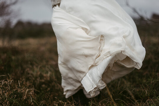 Crop bride on windy day in heath