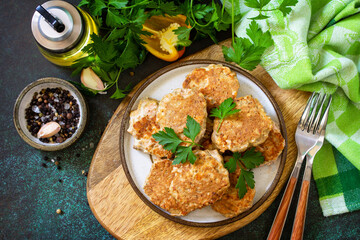 Healthy vegan food. Red fish cutlets on a dark stone or slate table. Top view flat lay background.