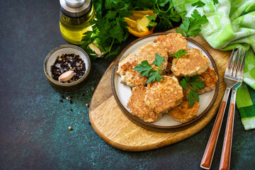 Healthy vegan food. Red fish cutlets on a dark stone or slate table. Copy space.