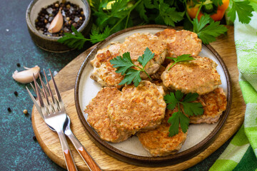 Healthy vegan food. Red fish cutlets on a dark stone or slate table.