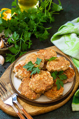 Healthy vegan food. Red fish cutlets on a dark stone or slate table.