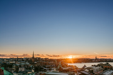 Sun setting over aged city and river