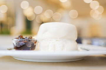 Bubble milk tea Soufflé pancake dessert. Japanese fluffy pancake topped with fresh cream and bubble/boba pearl with brown sugar syrup.