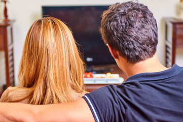 Fototapeta premium Couple watching having a movie night at home