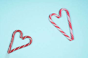 Candy canes in the shape of a heart on a light blue background