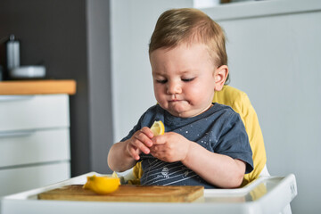 Toddler trying lemon for the first time.