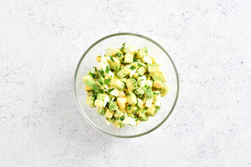 Avocado eggs salad in bowl