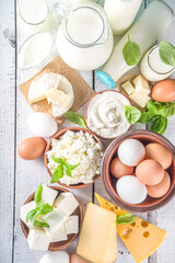 Set of Various Fresh Dairy Products - milk, cottage cheese, cheese, eggs, yogurt, sour cream, butter on wooden background