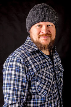 Solid bearded man in a wool cap portrait