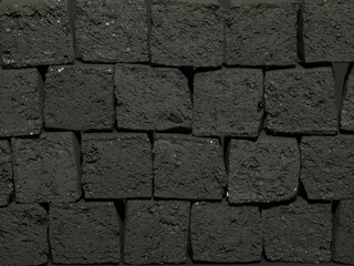 Black charcoal for hookah in cubes located on a dark background