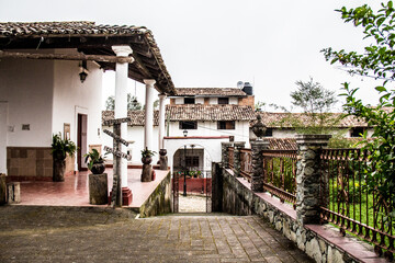 Fototapeta premium Cobbled street and adobe house in a Mexican old town, San Sebastian del Oeste, Jalisco, Mexico. Pueblo mágico, quiet street in a mexica town