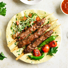 Adana Kebab with fresh vegetables on flatbread