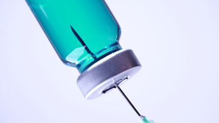 Filling syringe with vaccine from vial, extreme macro. Administrating medication with sterile...