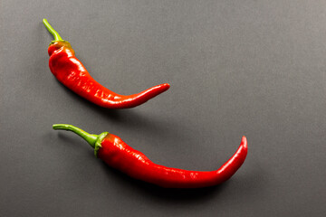  Red hot chili peppers two pieces on a dark background