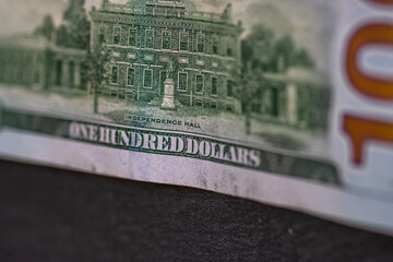 Selective focus on detail of 100 dollars banknote. Close up macro detail of money banknotes,...