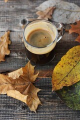 Espresso coffee and autumn leaves on the table 