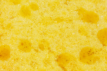 Macrophotography of yellow sponge texture close up view.