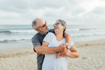 Retired couple hugging on the seashore