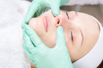 Beautiful girl gets face peeling. Skin health concept. Beauty salons.