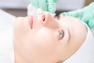 Beautiful girl gets face peeling. Skin health concept. Beauty salons.