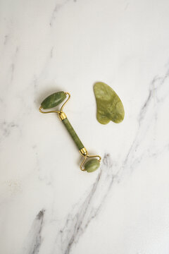 Skincare Jade Roller on Marble Tile