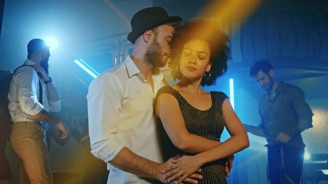 Young couple dancing together in a nightclub.