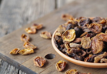 Home preparation of dried fruits. Wooden background with dried apricots.