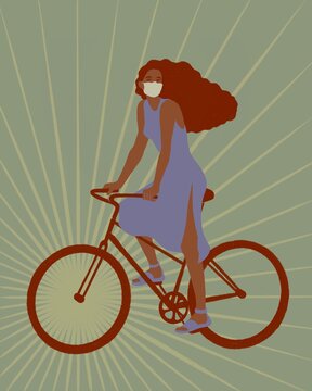Girl in a medical mask rides a bike