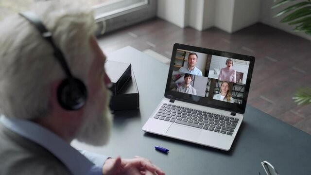 Close up of elderly man talk with diverse relatives on video call using laptop quarantine at home, man have online web conversation conference with family on computer