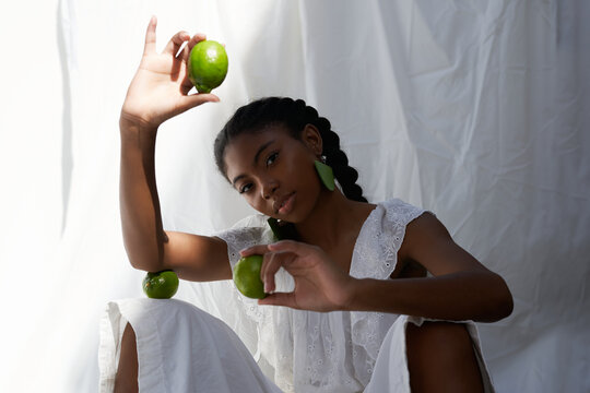 Dark Skinned Woman with Limes
