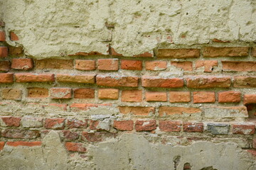 old textured wall with elements of brickwork, beige orange background, ancient architecture