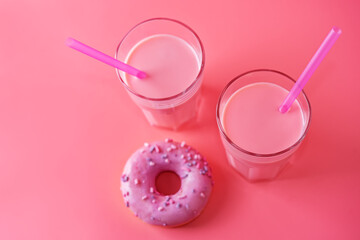 Pink milk cocktail in a glass with merengue cookies