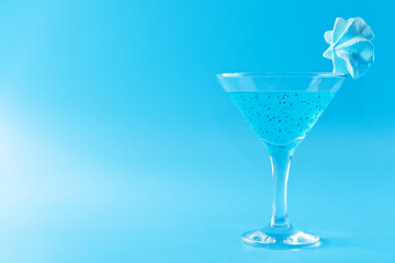Blue milk cocktail in a glass with merengue cookies