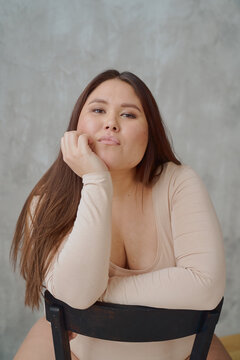 portrait of a beautiful young Asian woman real body in a swimsuit