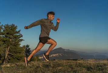 man doing sports outdoors and doing a jump