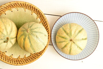fragrant organic melons, close-up, on a white wooden table.