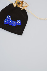 Vertical shot of blue dice on dice bag isolated on white background