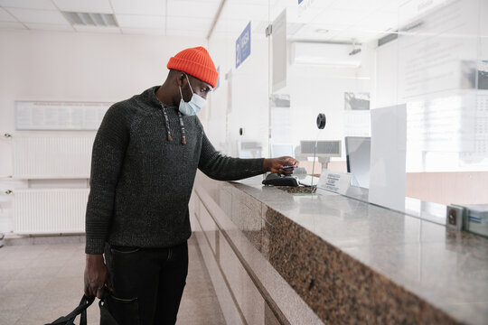 Black Man Wearing Face Mask Using Credit Card To Pay - Powered by Adobe