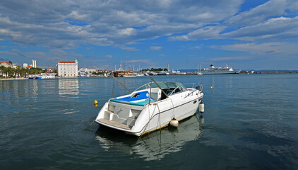 Fototapeta premium Power Boat moored at the harbour of Split Croatia with blue sky and clouds.