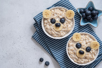 Kids breakfast oatmeal porridge with funny bear face