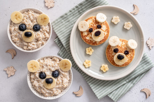 Naklejki Kids breakfast oatmeal porridge and pancakes with funny bear face