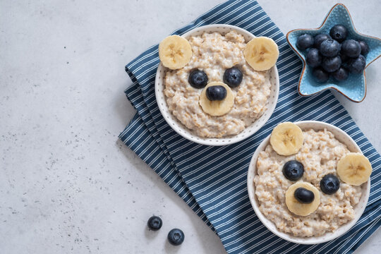 Naklejki Kids breakfast oatmeal porridge with funny bear face