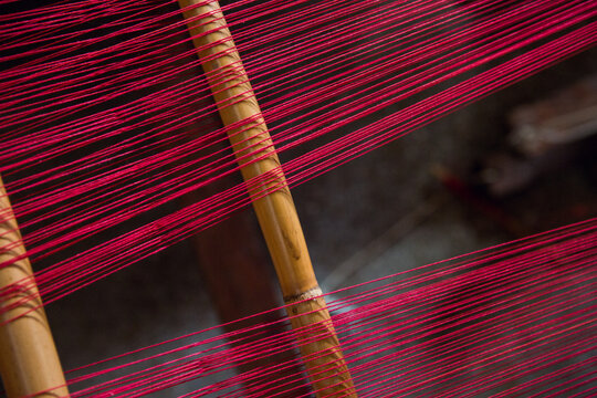 Red thread on wooden poles
