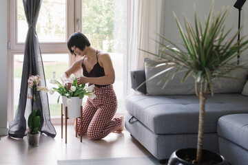 Woman Putting Flowers In The Vase