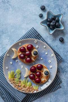 Naklejki Cute fish pancakes with fruit for kids breakfast