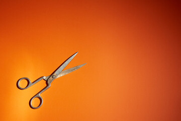 old scissors on a orange background