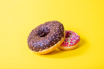 Colorful delicious two donuts with sugar glaze on top
