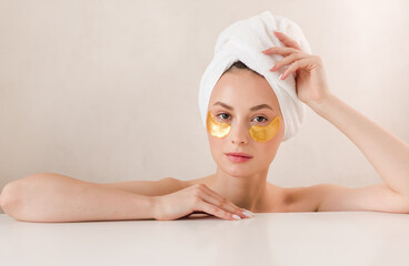 Taking care of her skin. Woman using eye patches spending time at home. Daily pampering routine. Eye patches concept.