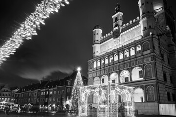 the facade of Renaissance town hall and christmas decorations in city of Poznan, monochrome
