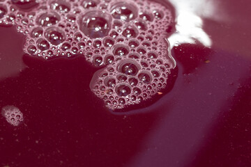 Wine making. Fresh grape juice with foam. Must flows and is collected in a special container.Technology of wine production in Moldova. The  ancient folk tradition of grape processing. Harvest home.